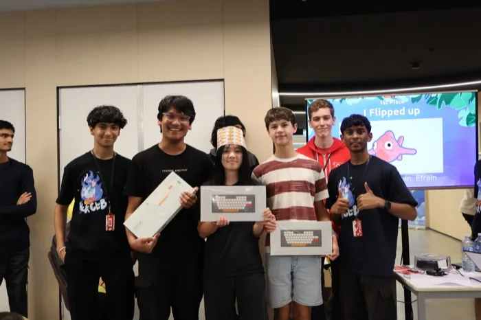 Attendees holding up their prizes