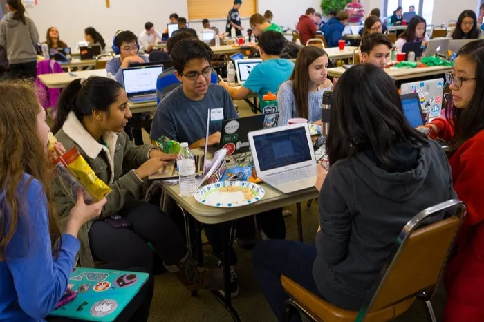 A group of teens working at a shared table